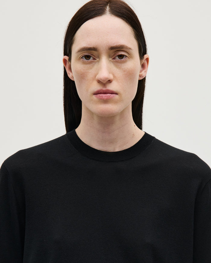Black Babaà No50 women's jumper displayed on a woman, showcasing a stylish, cozy knit sweater in a casual fashion pose.