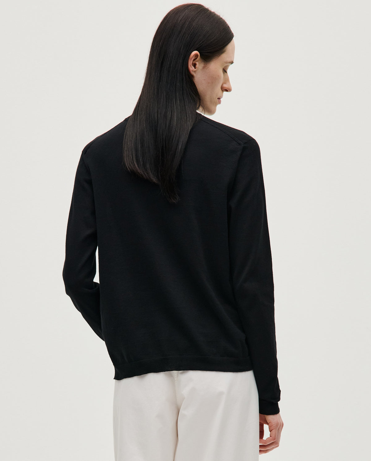 Black Babaà No50 jumper worn by woman, showcasing a cozy, stylish knit sweater with a relaxed fit.