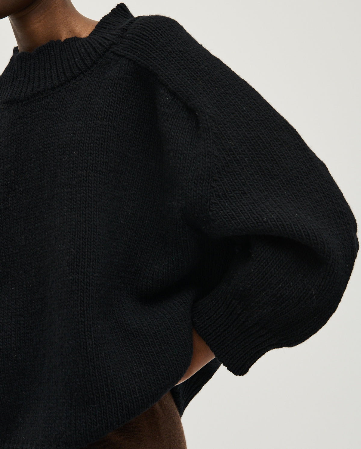 Black Babaà No51 jumper worn by a woman, showcasing a stylish, cozy knit with a relaxed fit and modern design.