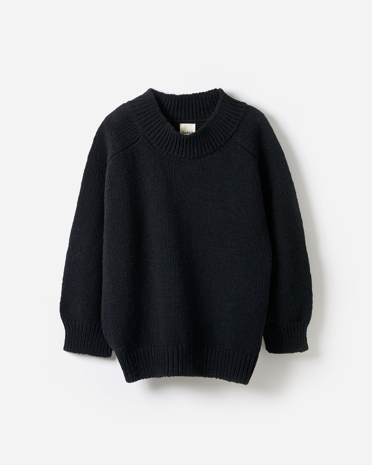 Black Babaà No51 jumper on a woman, showcasing a stylish, relaxed fit in a silhouette profile.
