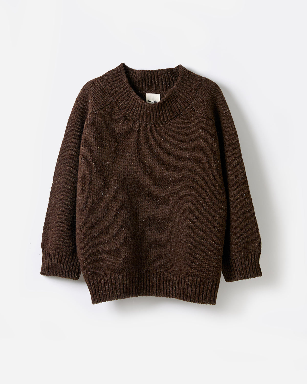 Silhouette of a woman wearing Babaà No51 Earth jumper, showcasing its relaxed fit and earthy tone in natural indoor lighting.