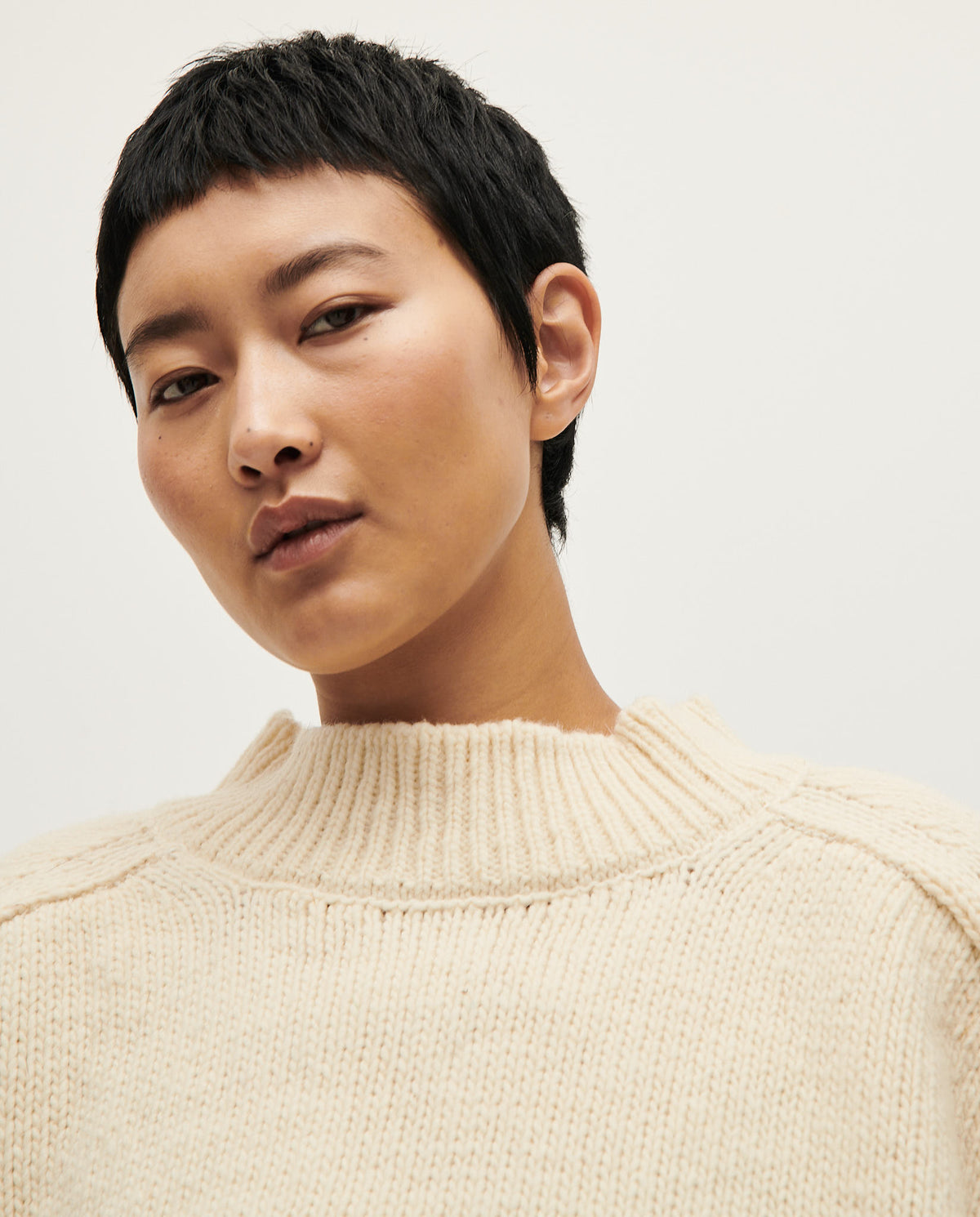 Woman wearing Babaà No51 natural jumper, soft knit sweater with a relaxed fit and neutral beige color.