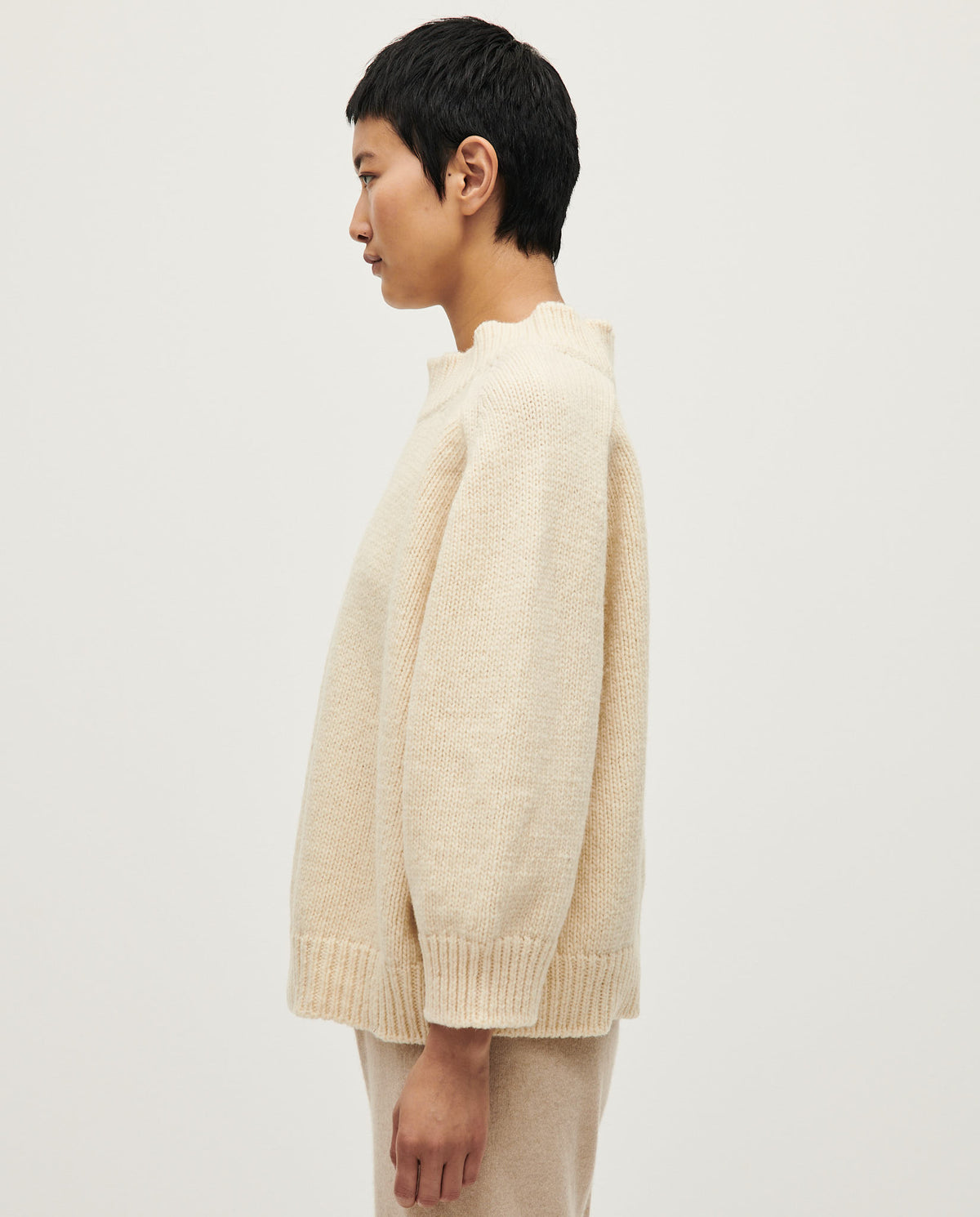 Woman wearing Babaà No51 natural jumper, soft knit sweater with a relaxed fit, showcasing casual style and neutral color.