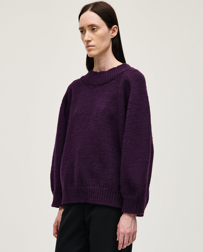 Woman wearing Babaà No51 purple jumper, soft knit sweater with long sleeves and cozy fit, styled casually.