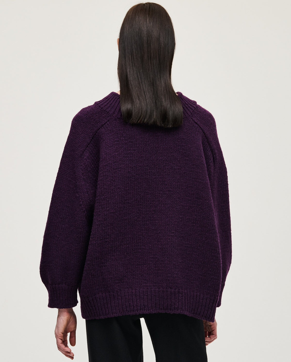 Woman wearing Babaà No51 purple jumper, showcasing cozy knit sweater in vibrant purple color.