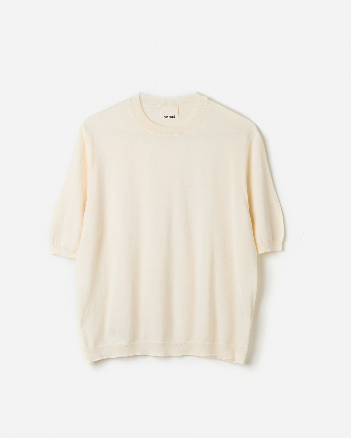 Woman wearing Babaà No59 Natural jumper, showcasing its relaxed fit and soft knit texture in a casual silhouette.