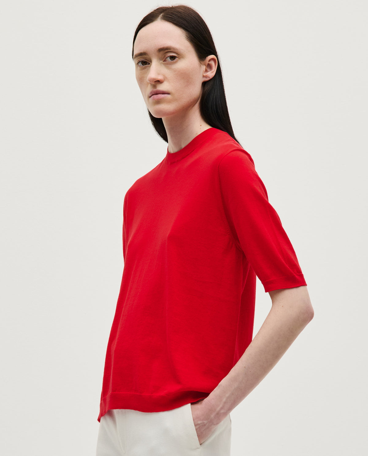 Red Babaà jumper No59 worn by a woman, featuring a cozy knit design, perfect for casual and stylish winter outfits.