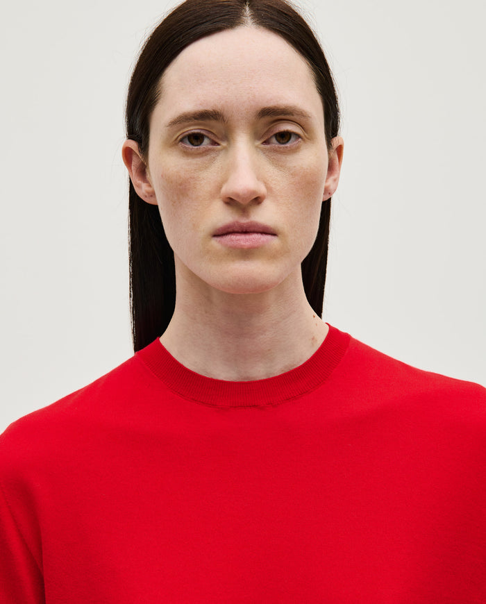 Red Babaà jumper No59 worn by a woman, showcasing the cozy knit fabric and stylish fit.