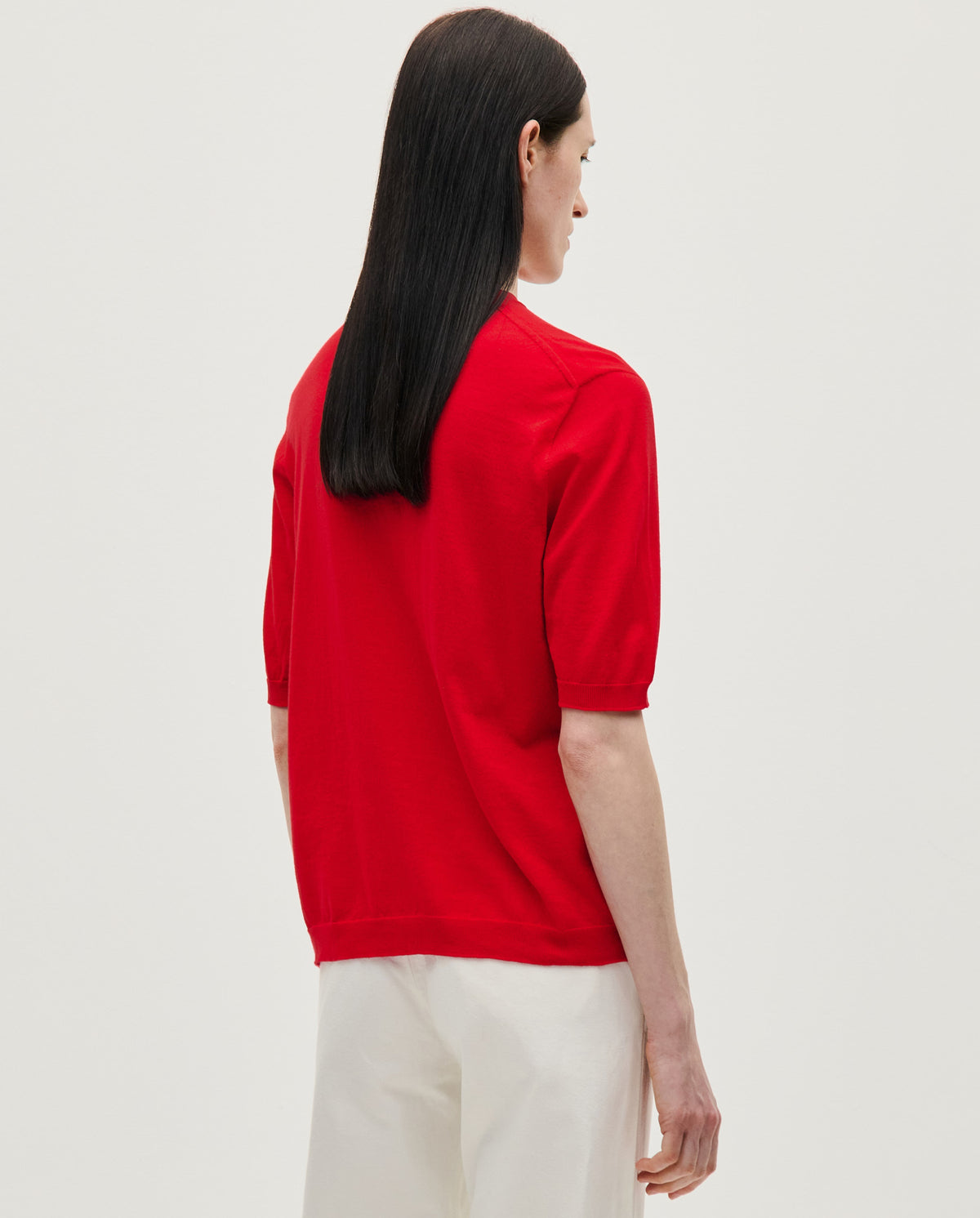 Red Babaà Jumper No59 worn by a woman, showcasing a stylish knit sweater with a cozy fit and vibrant color.