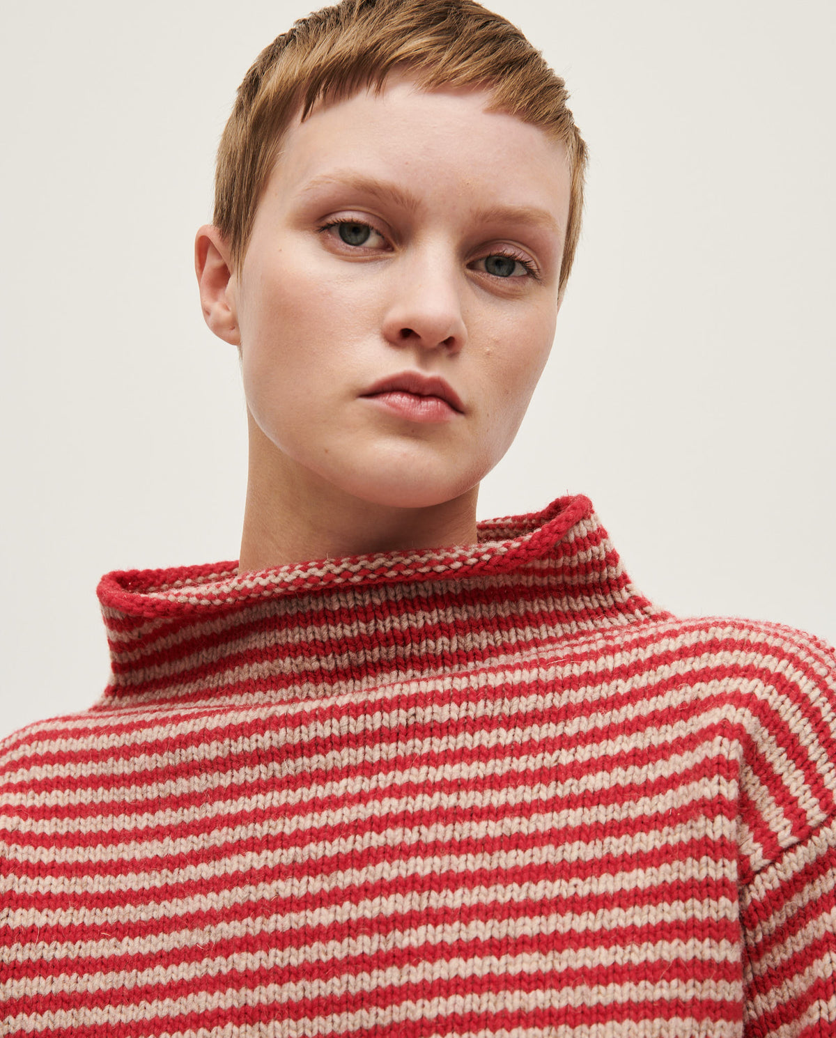 Woman wearing Babaà Jumper No6 Ruby, a stylish knit sweater in vibrant ruby red.