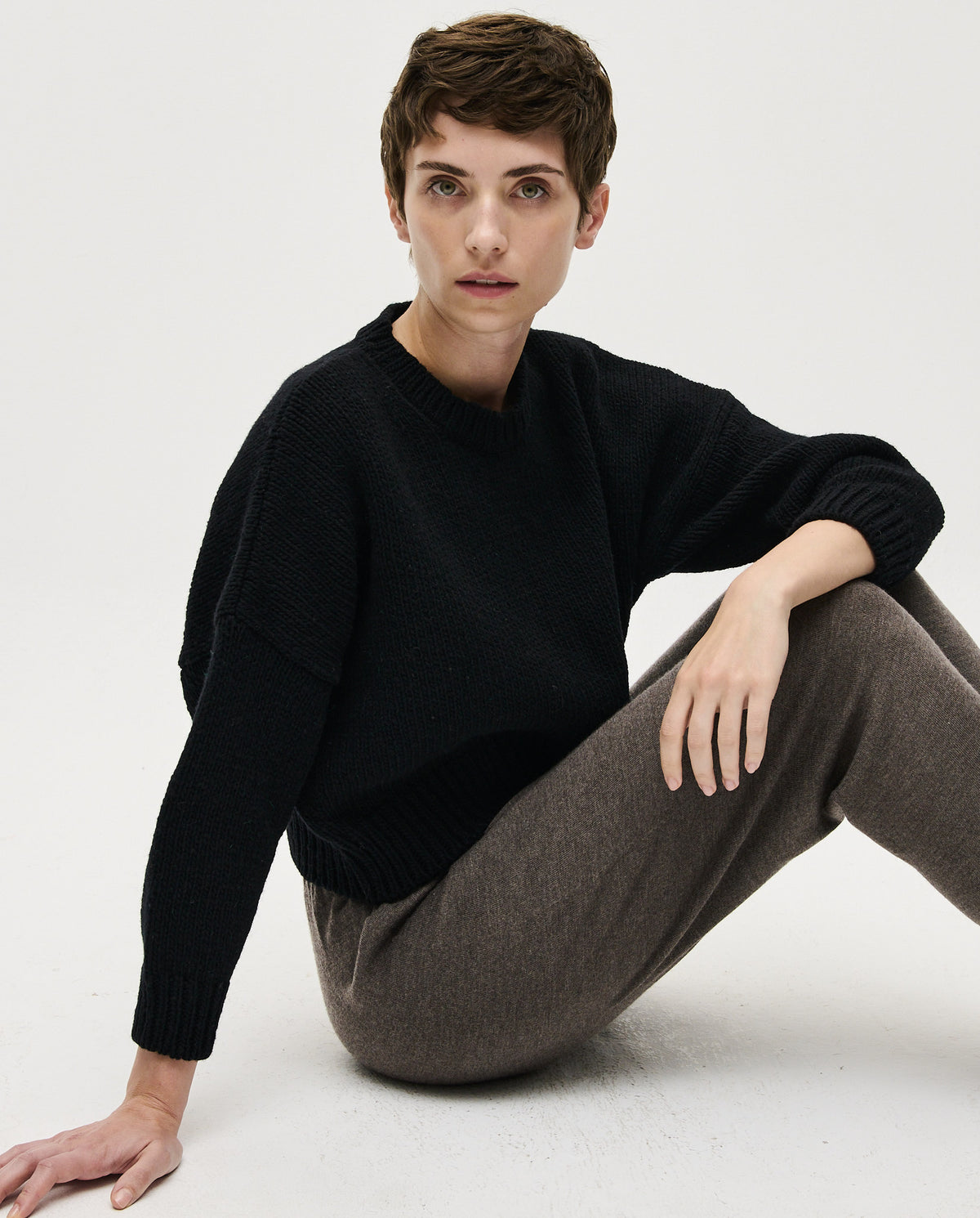Black Babaa Jumper No61 worn by a woman, showcasing a stylish, cozy knit sweater with a relaxed fit and detailed texture.