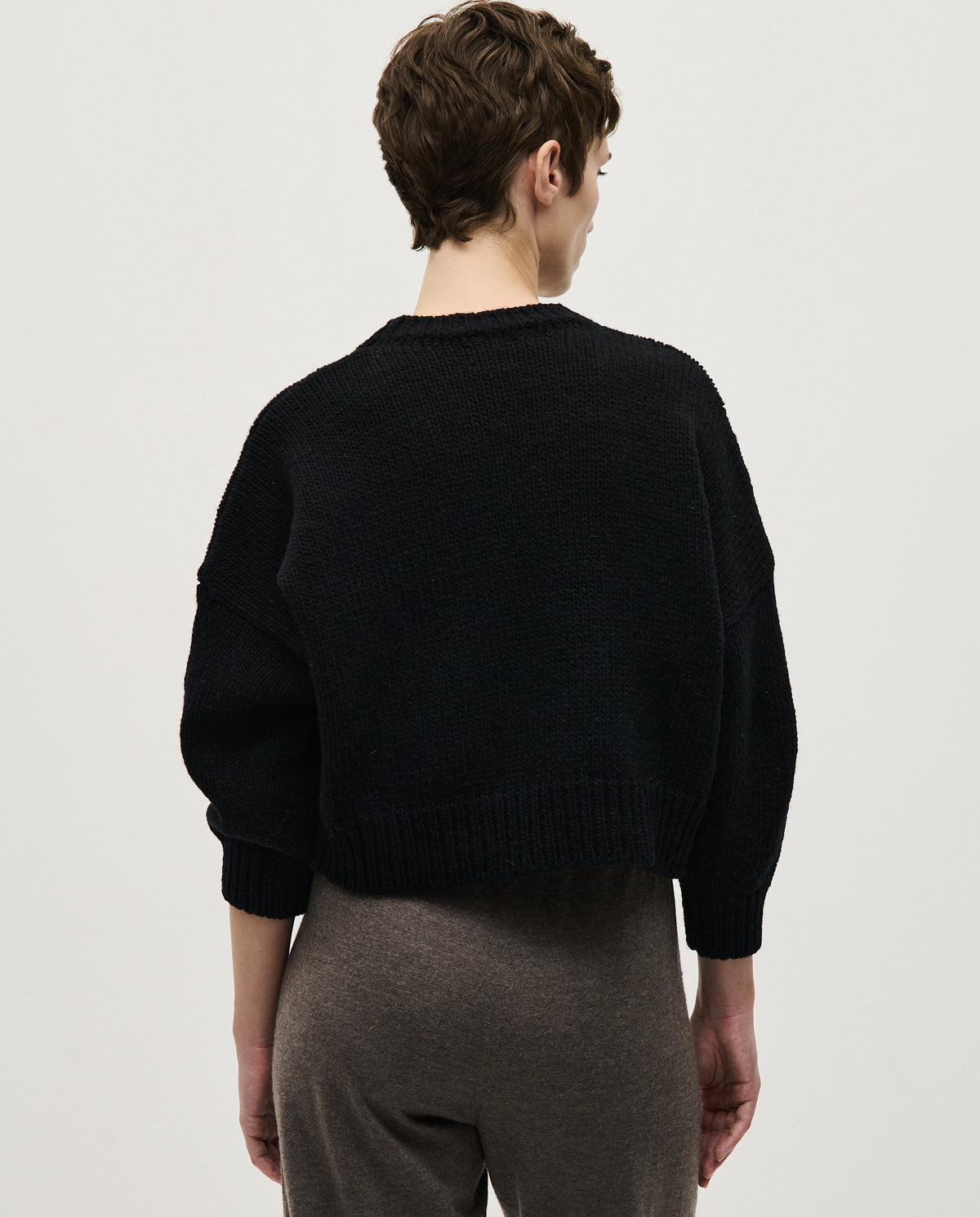 Black Babaà Jumper No61 worn by a woman, showcasing the cozy knit fabric and stylish fit.