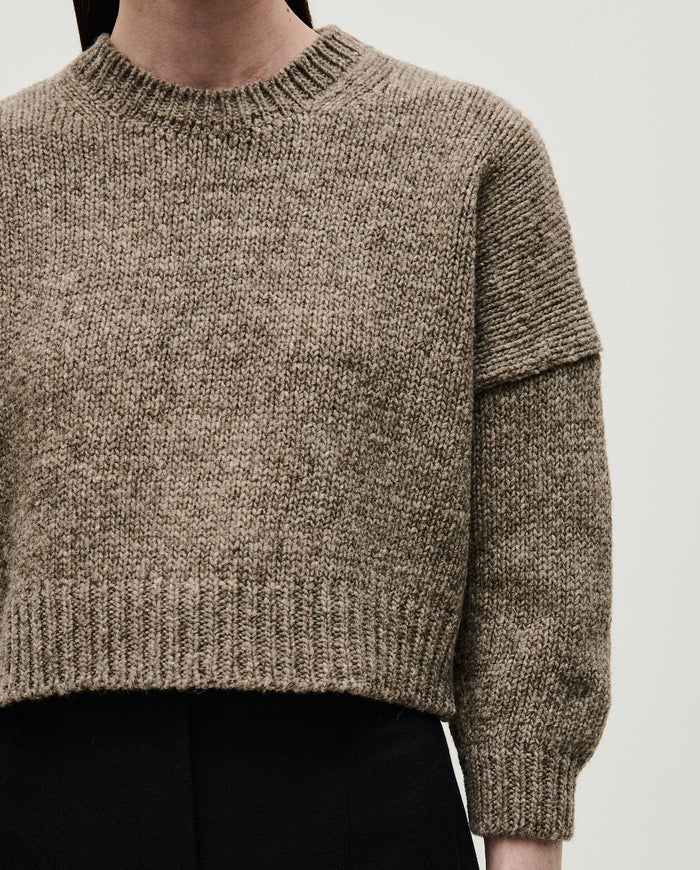 Woman wearing Babaà No61 Dark Mist jumper, showcasing the cozy, stylish knit sweater with a relaxed fit.