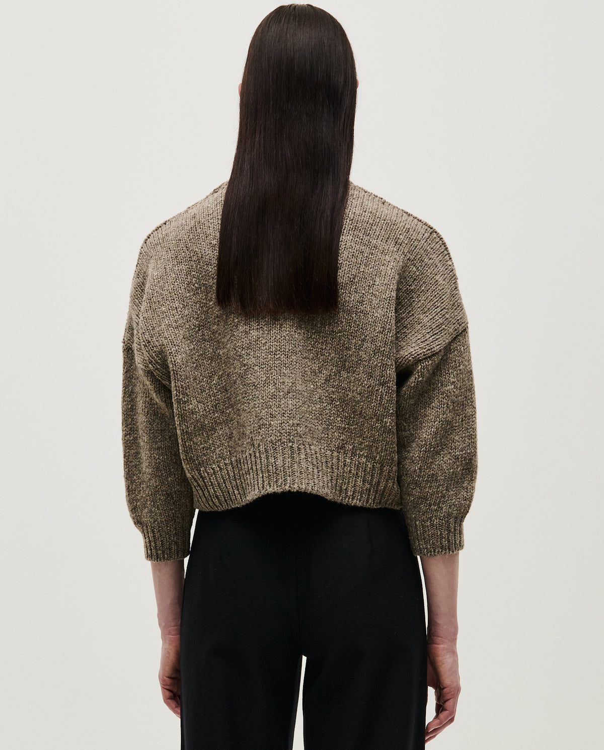 Woman wearing Babaà Jumper No61 in Dark Mist, showcasing its cozy fit and soft knit fabric.