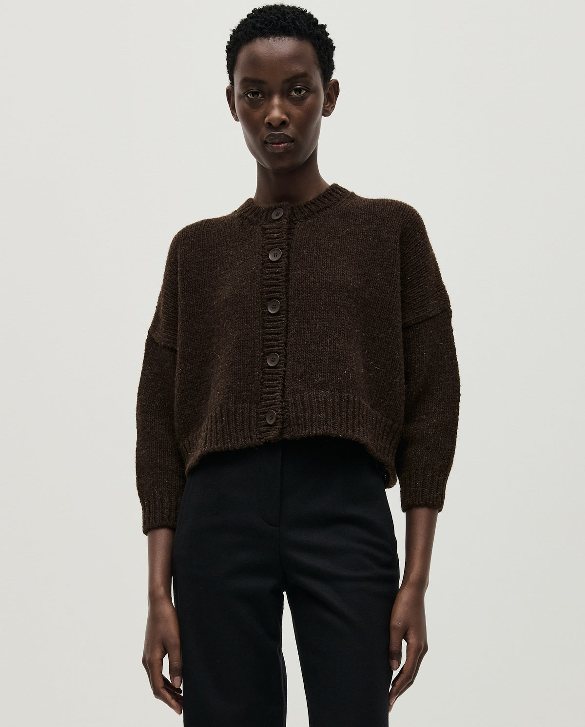 Babaà No61 Earth cardigan worn by a woman, showcasing the cozy knit sweater with earthy tones and relaxed fit.