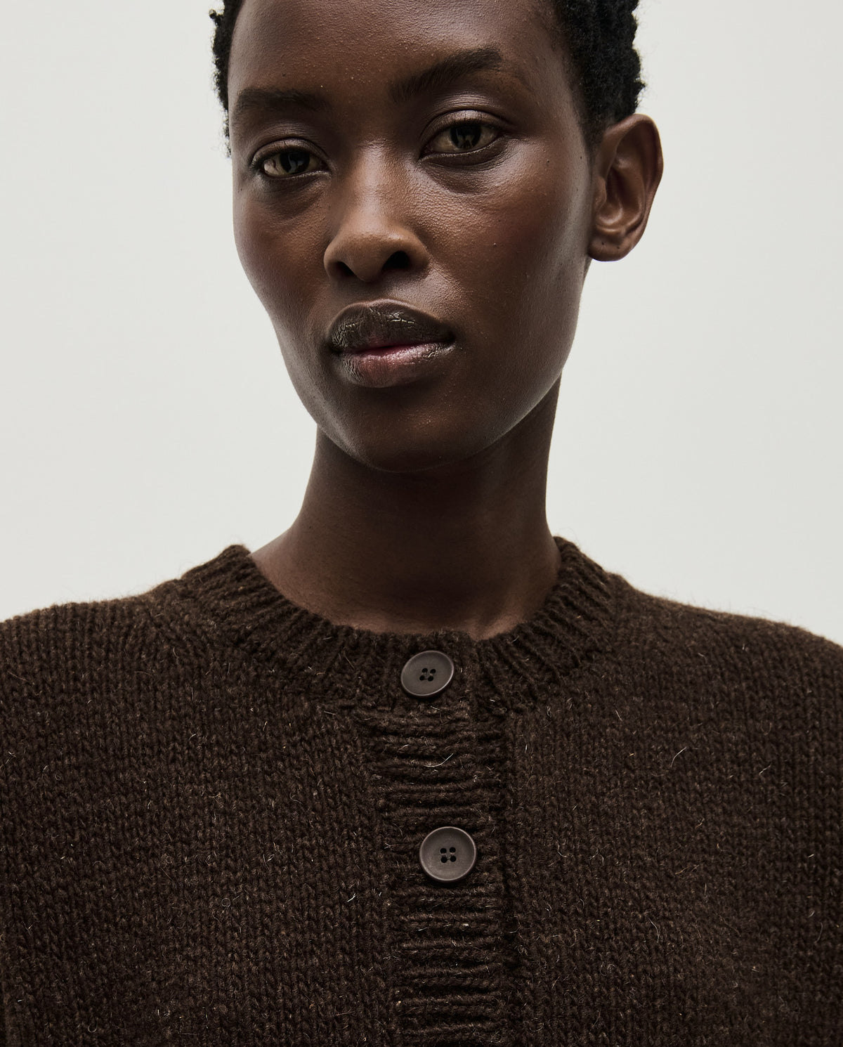 Babaà No61 Earth cardigan worn by a woman, featuring a cozy, earthy-toned knit with button details and a relaxed fit.