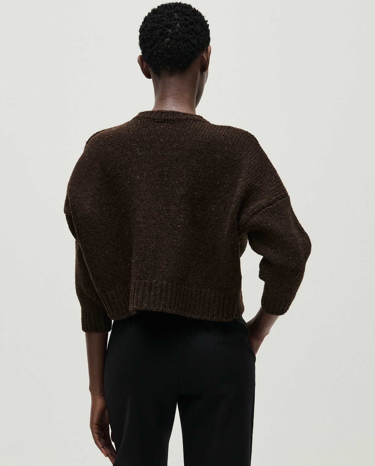 Babaà No61 Earth cardigan worn by a woman, featuring earthy tones and a cozy, knitted design.