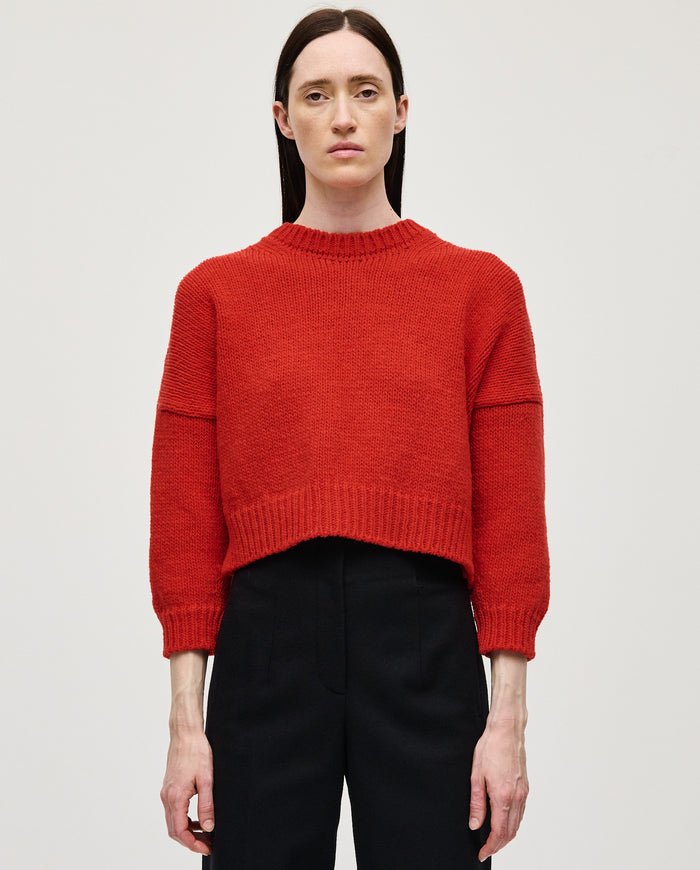 Babaà No61 red women's jumper, soft knit sweater with a cozy fit, shown on a woman in a casual indoor setting.