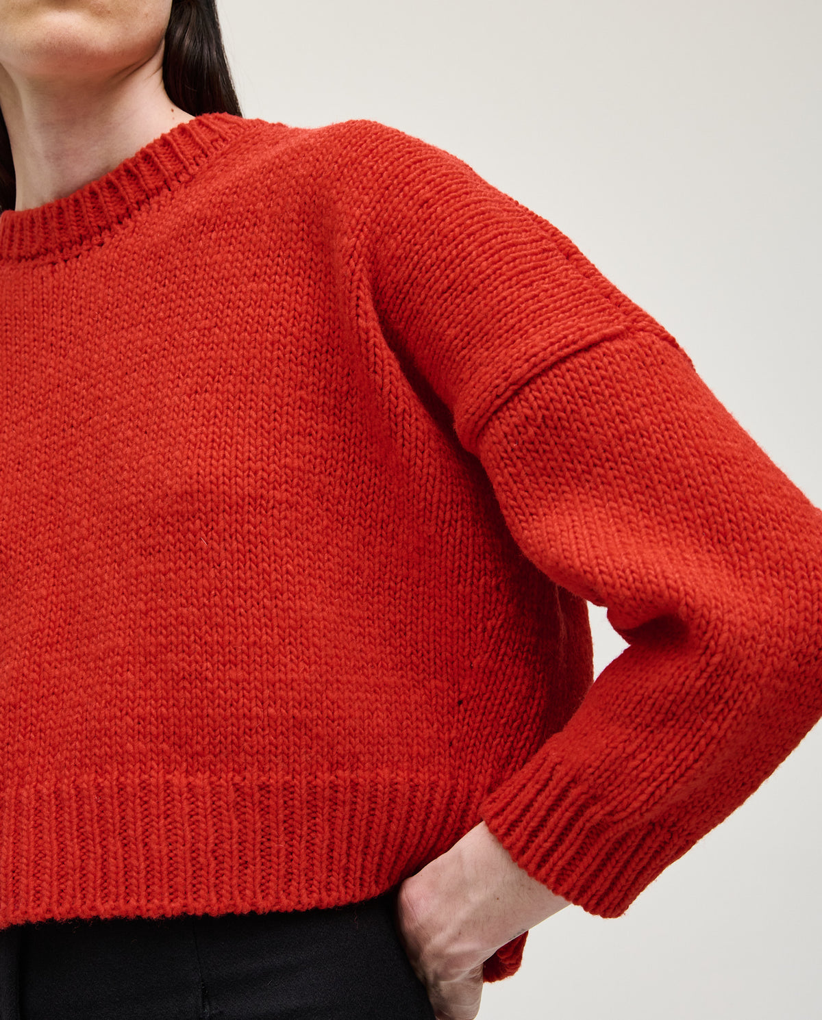 Woman wearing Babaà No61 red jumper, featuring a cozy knit design and relaxed fit, perfect for casual and stylish looks.