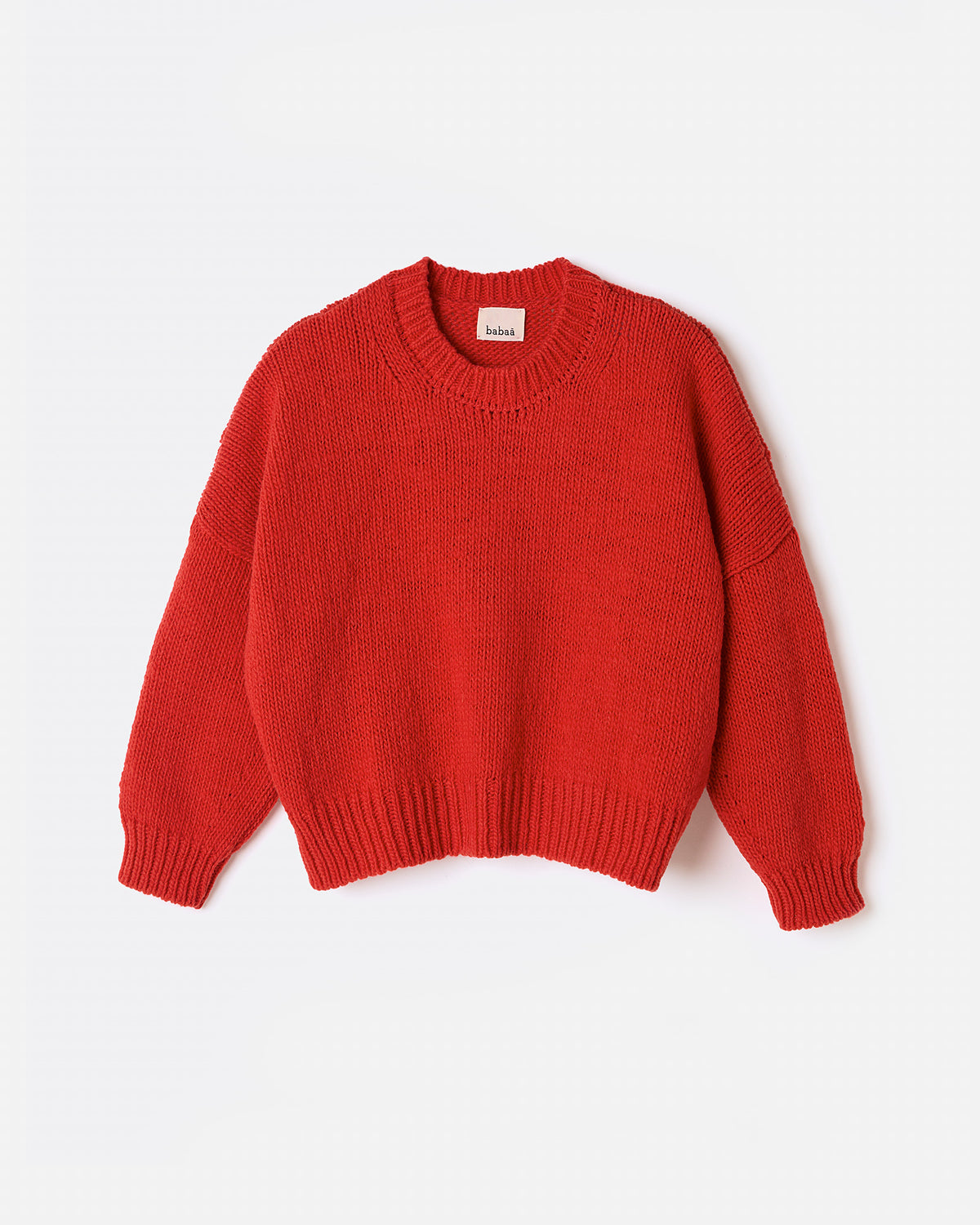 Silhouette of a woman wearing Babaà No61 red jumper, showcasing its cozy fit and vibrant color.
