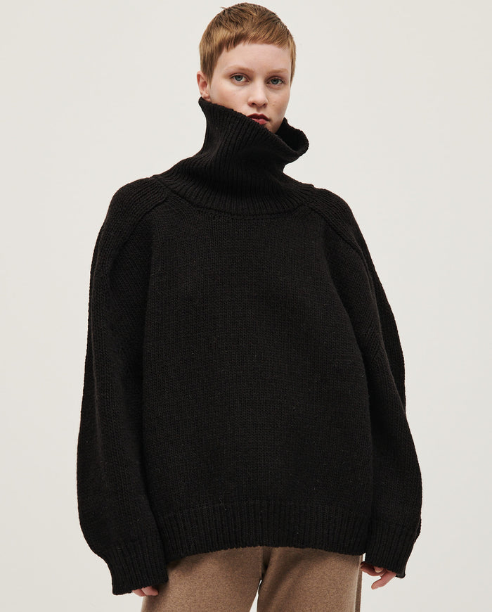 Black Babaà Jumper No67 worn by woman, showcasing a stylish knit sweater with a relaxed fit and cozy design.