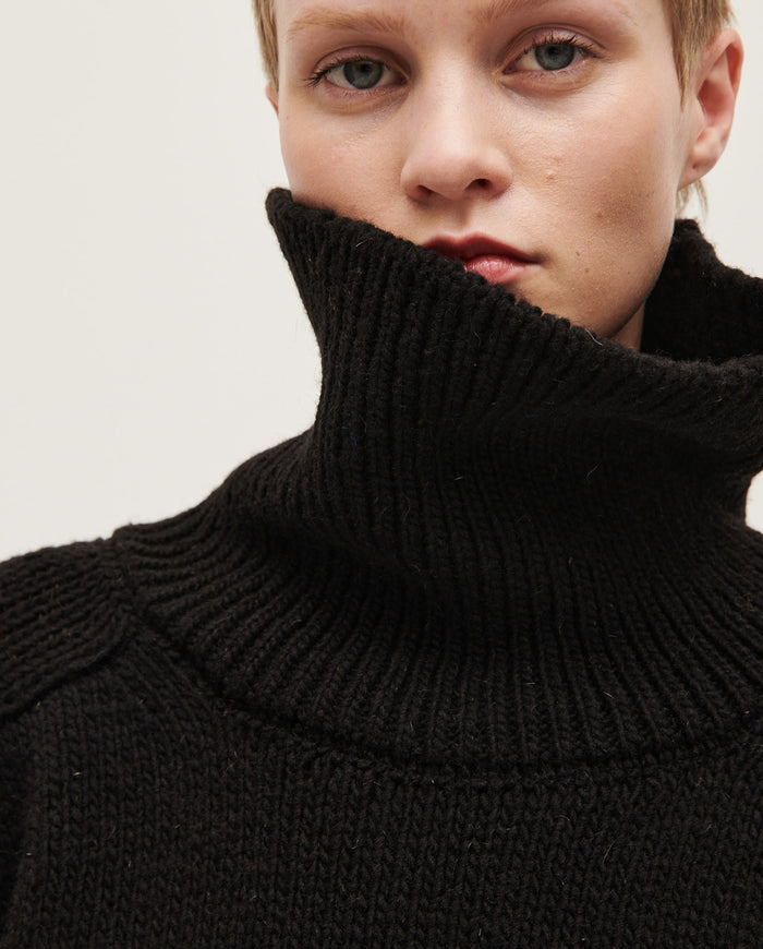 Black Babaà Jumper No67 worn by a woman, showing a cozy, stylish knit sweater with a relaxed fit and textured fabric.