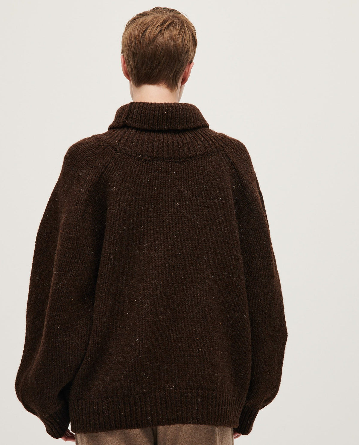 Woman wearing Babaà No67 Earth jumper, showcasing the cozy, earthy-toned knit sweater styled for casual wear.