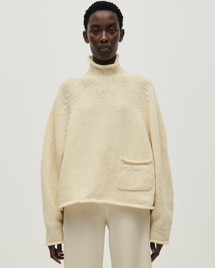 Woman wearing Babaà No70 Natural jumper, featuring a cozy, relaxed fit in soft natural fabric, ideal for casual wear.