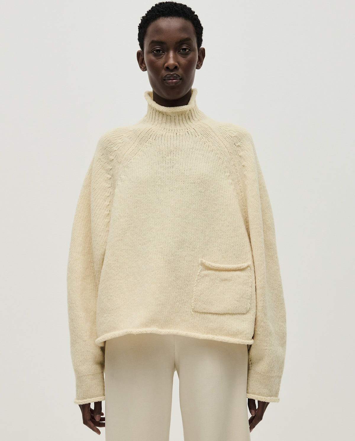 Woman wearing Babaà No70 Natural jumper, featuring a cozy, relaxed fit in soft natural fabric, ideal for casual wear.