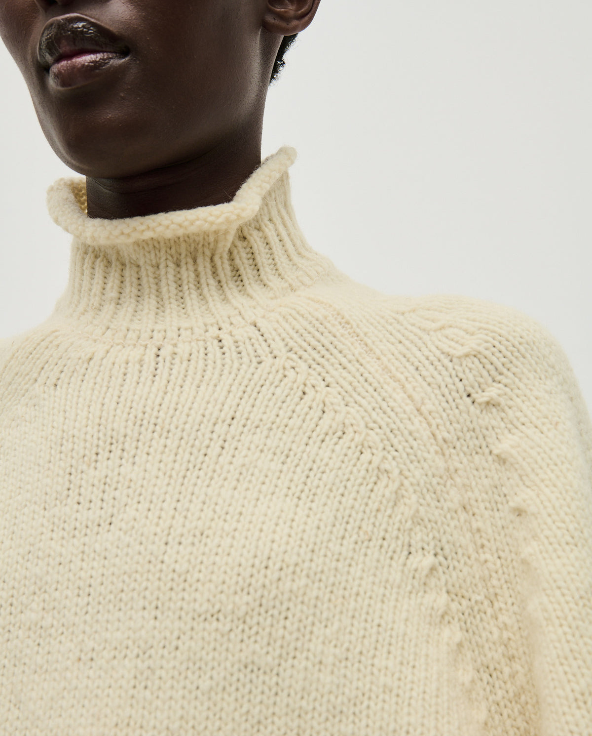 Woman wearing Babaà No70 Natural jumper, showcasing the cozy, beige knit sweater with a relaxed fit and textured fabric.