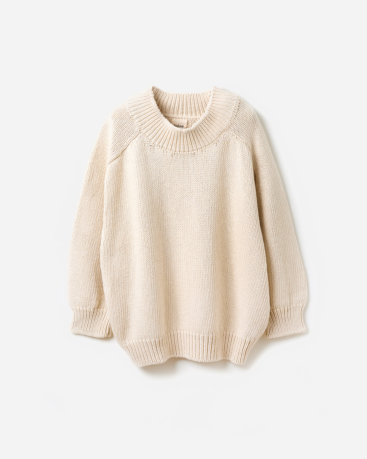 Woman wearing Babaà No72 natural jumper, showcasing the relaxed fit and soft fabric in a side silhouette view.