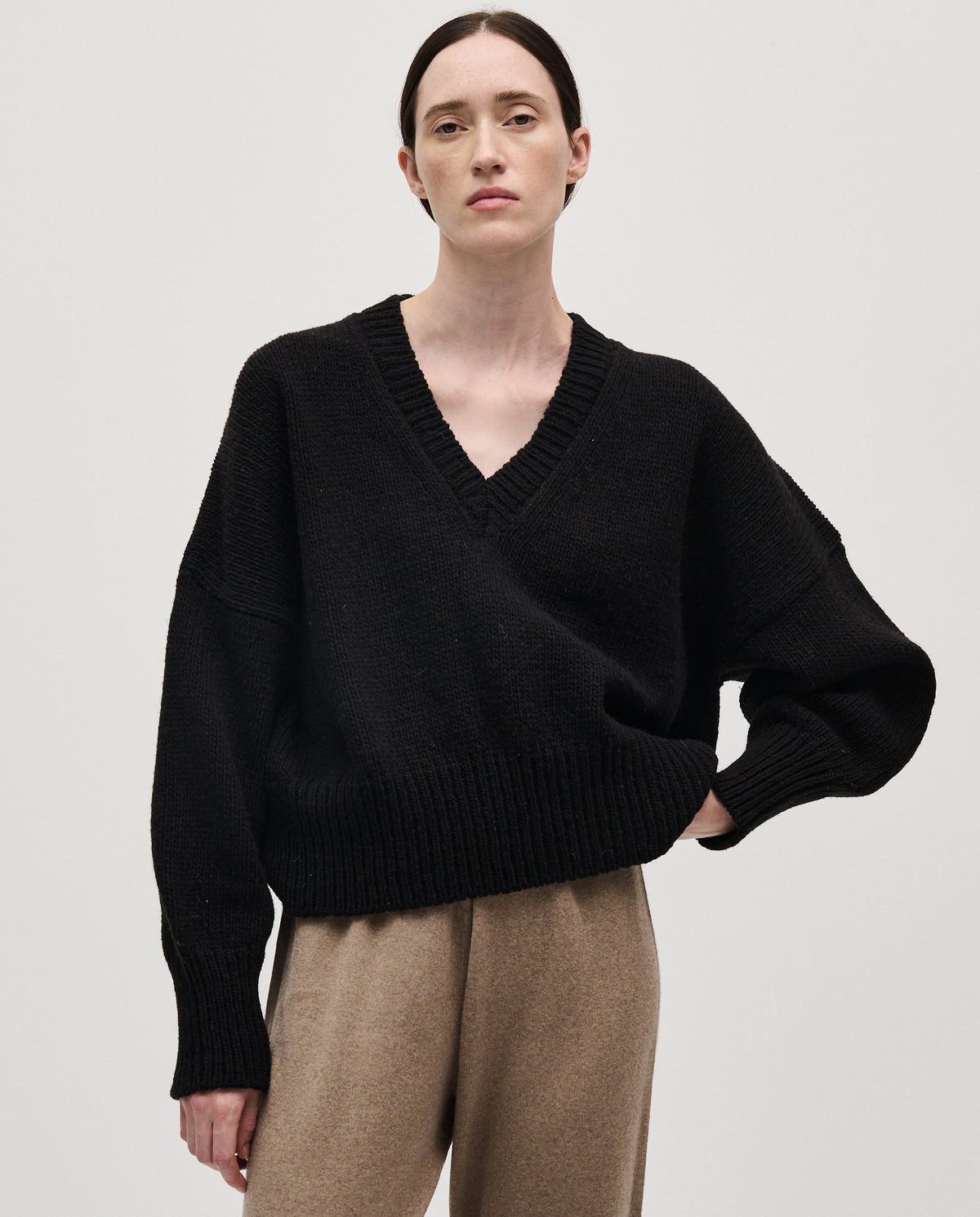 Black Babaà No75 women's jumper displayed on a woman, showcasing the cozy knit fabric and stylish design.