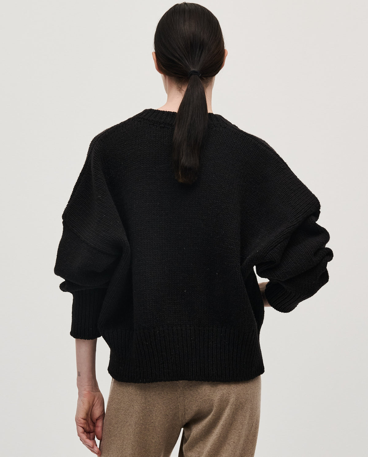 Black Babaà No75 women's jumper displayed on a woman, featuring a cozy, stylish knit design perfect for casual wear.