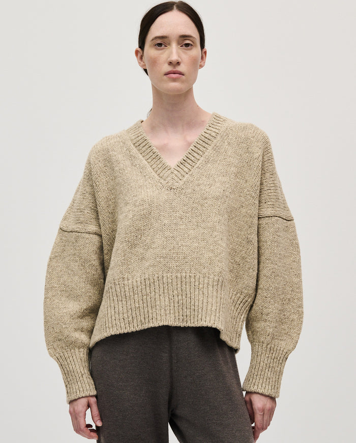 Woman wearing Babaà No75 Mist jumper, featuring a cozy knit design in soft mist color, perfect for casual winter wear.