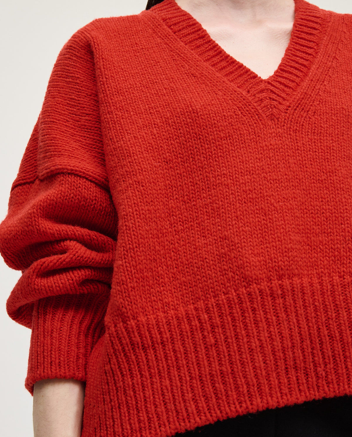 Red Babaà No75 women's jumper displayed on a woman, featuring a cozy knit design and a relaxed fit.