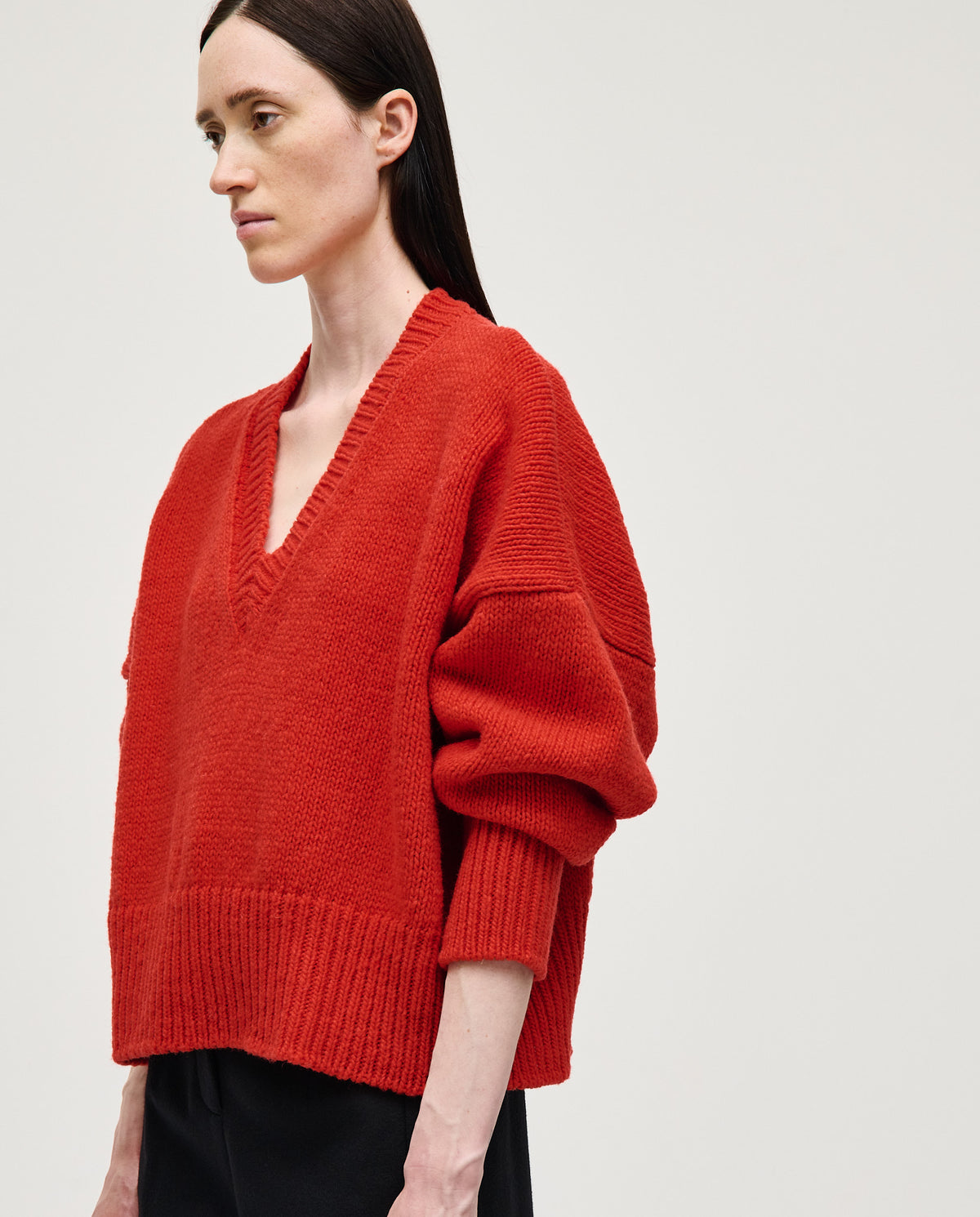 Woman wearing Babaà Jumper No75 in vibrant red, showcasing a stylish, cozy knit sweater for casual wear.