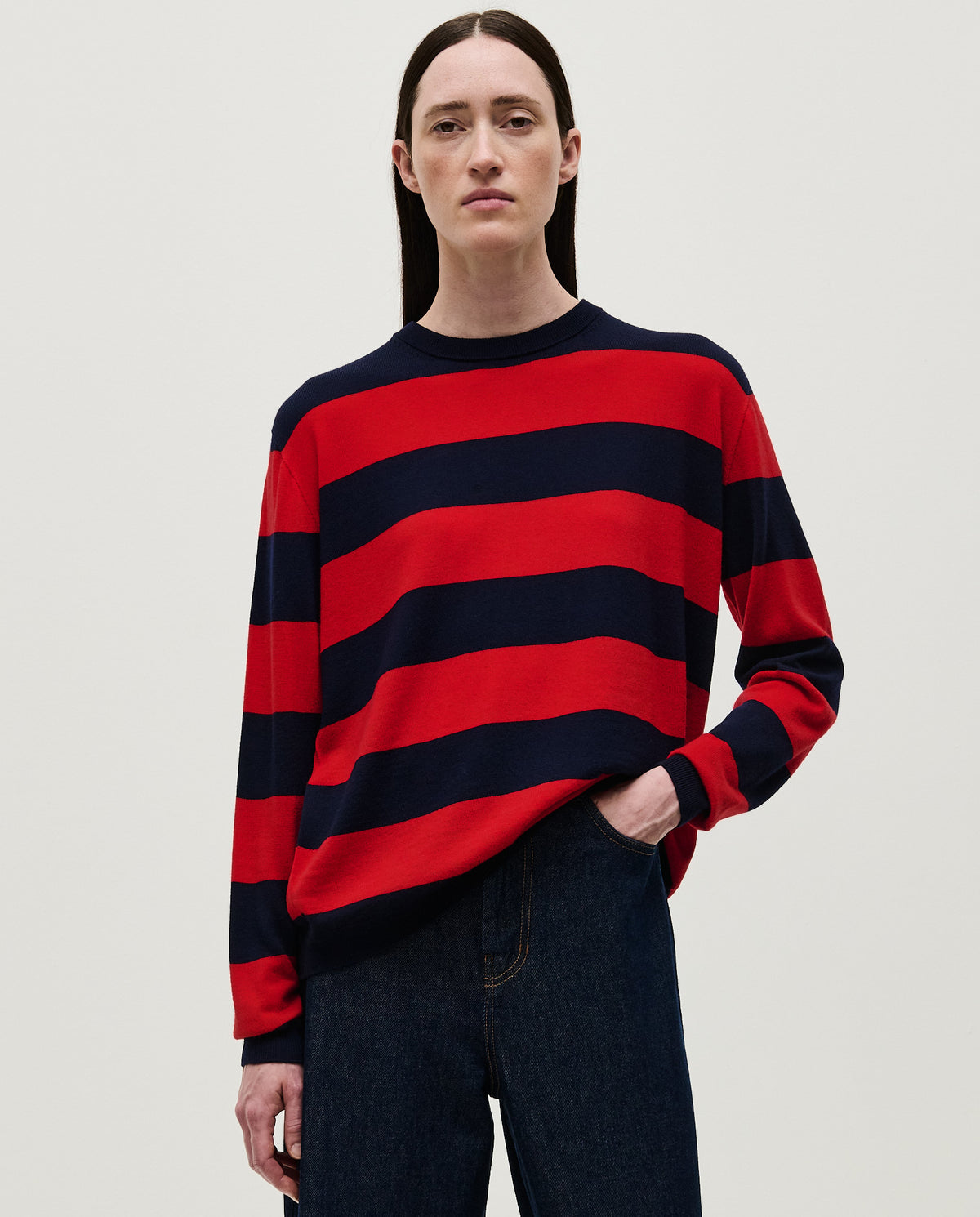 Woman wearing Babaà No84 Poppy jumper, featuring a cozy knit design in vibrant red with a relaxed fit.