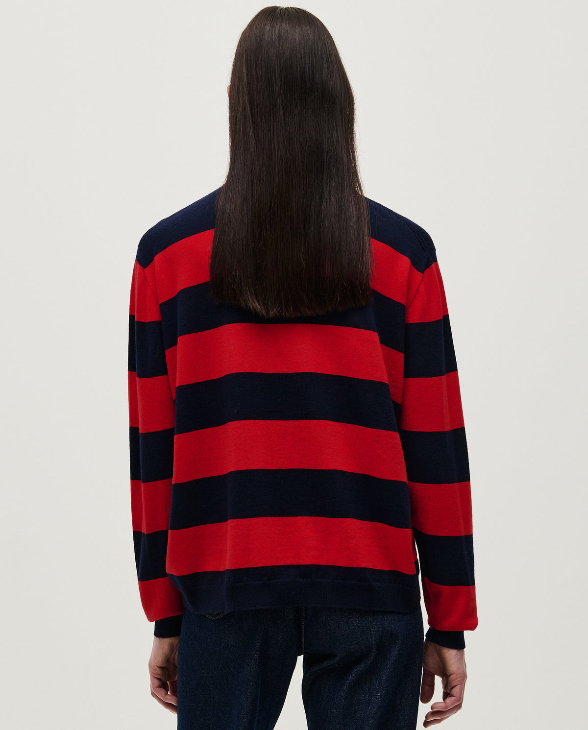 Woman wearing Babaà No84 Poppy jumper, stylish knit sweater with vibrant orange color and cozy fit.