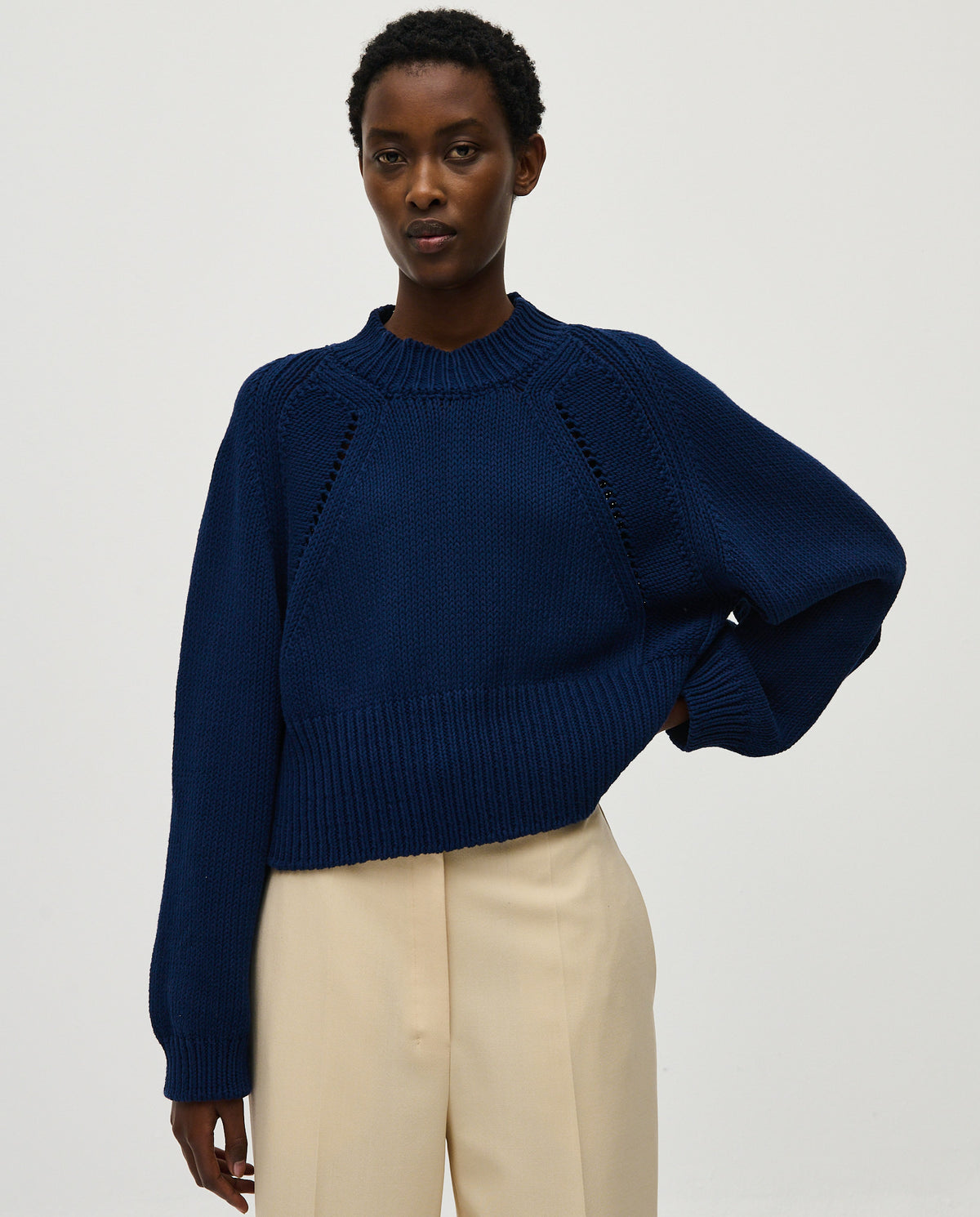 Navy jumper No86 by Babaà, worn by a woman, showcasing its cozy knit texture and stylish fit.