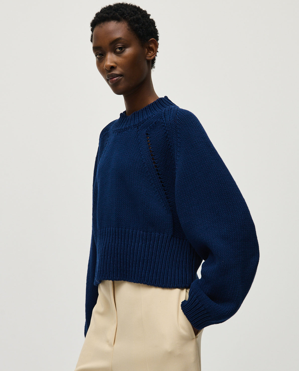Navy jumper No86 by Babaà worn by a woman, showcasing its cozy knit fabric and stylish fit.