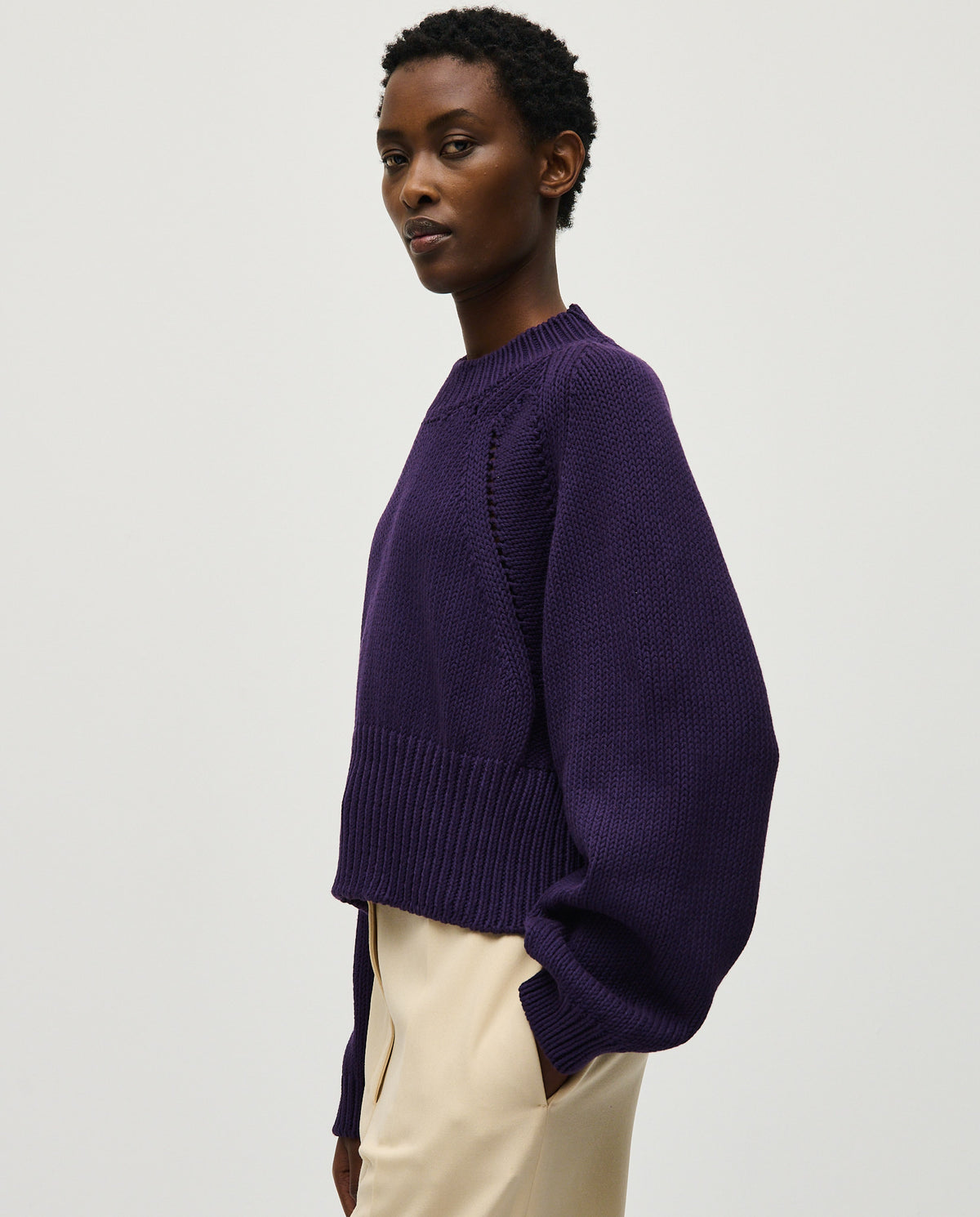 Woman wearing Babaà No86 Ridge jumper in a cozy, stylish knit with a high neckline and relaxed fit.