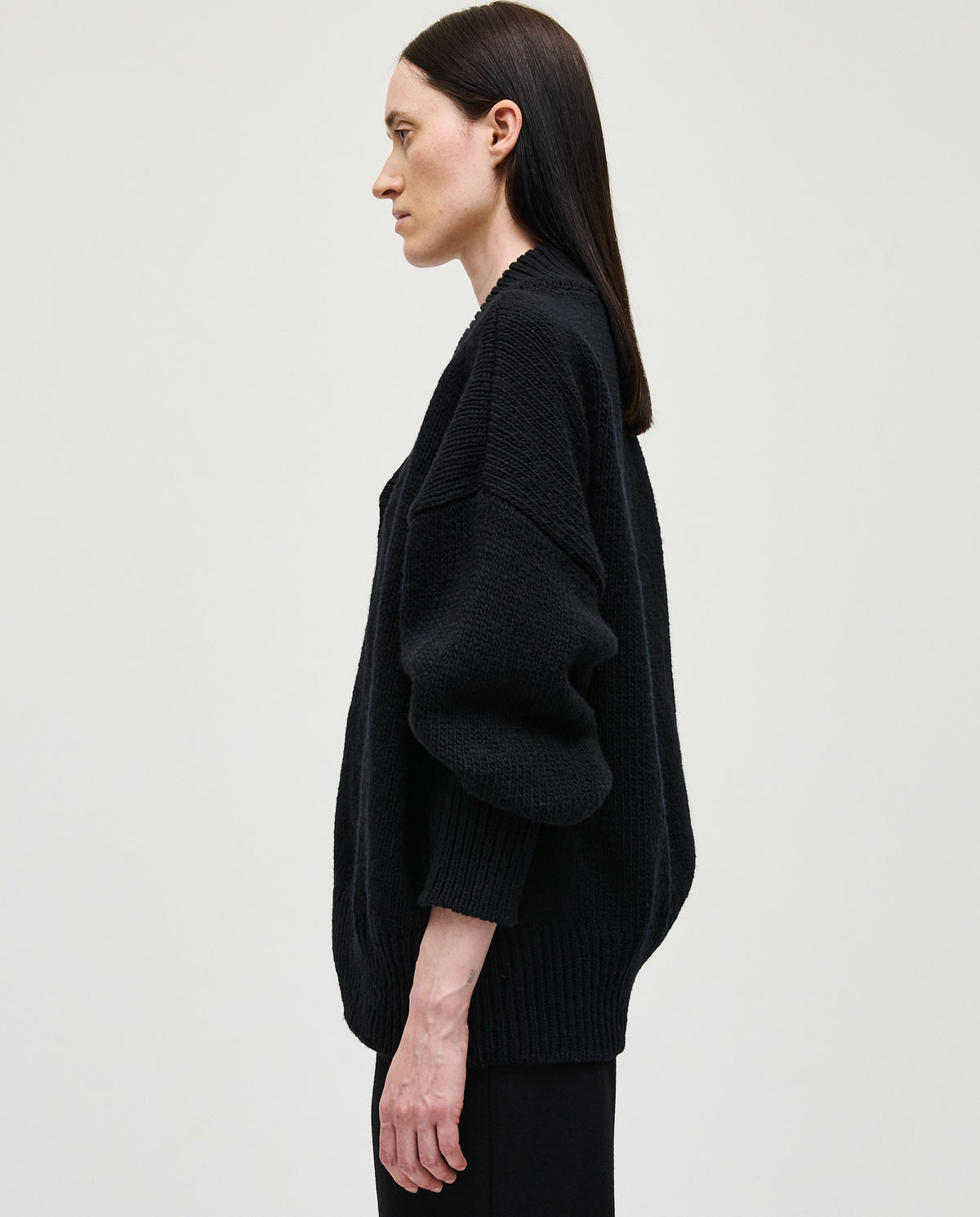 Black Babaà Jumper No87 worn by a woman, featuring a cozy, stylish design with a high neckline and long sleeves.