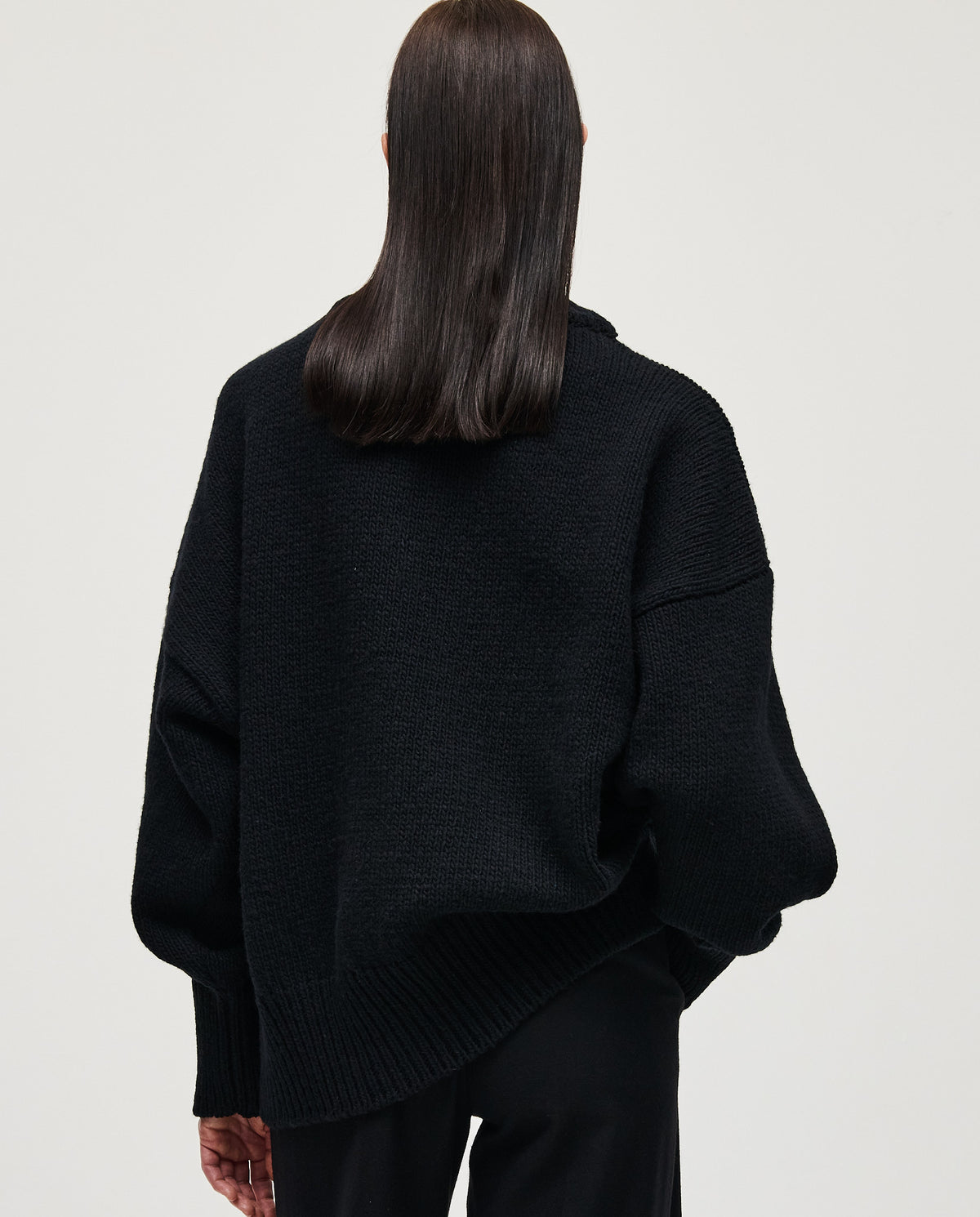 Black Babaà Jumper No87 worn by a woman, showcasing a cozy, stylish knit sweater with a relaxed fit and textured fabric.