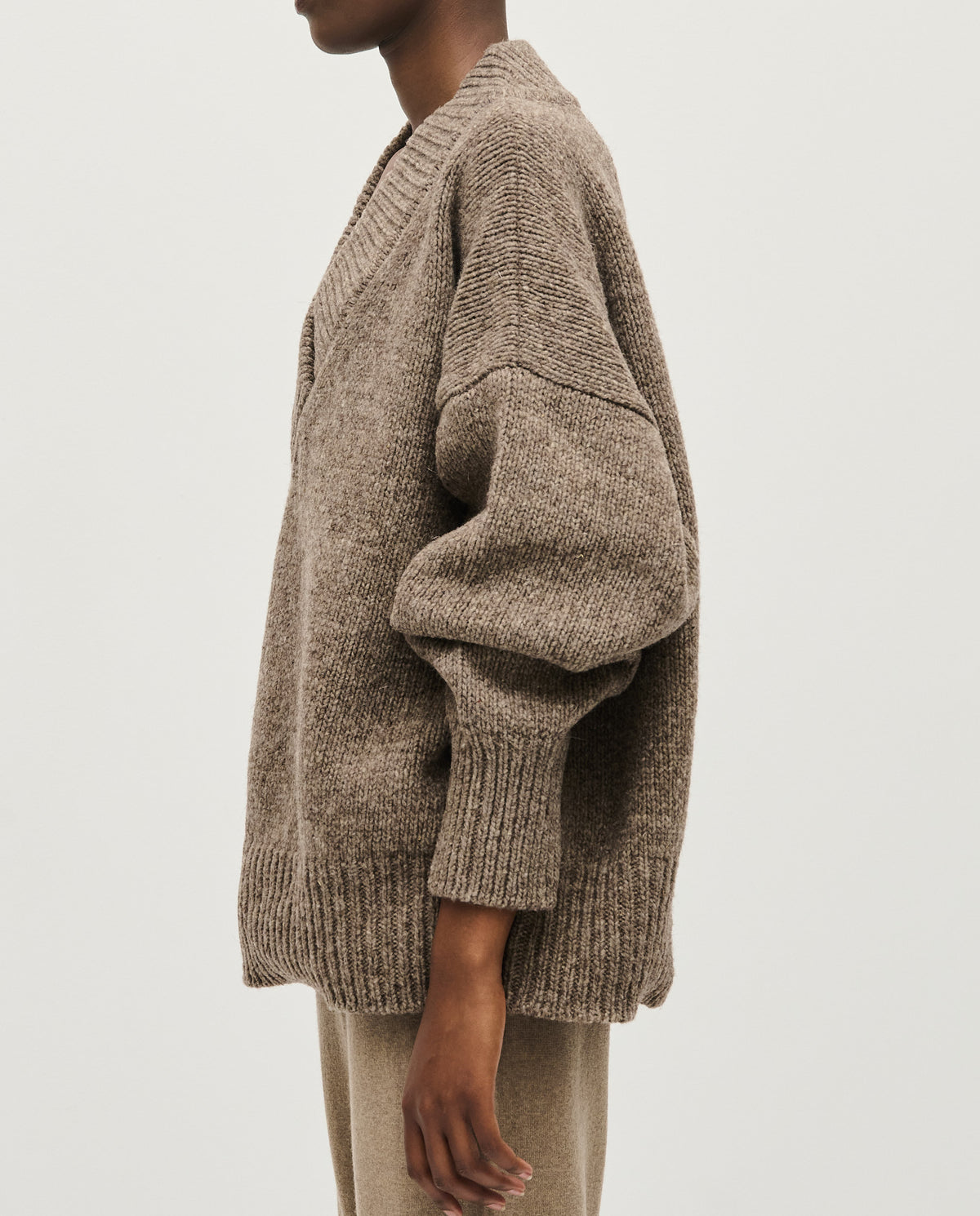 Woman wearing Babaà No87 dark mist jumper, showcasing a cozy knit sweater with a relaxed fit and soft fabric.