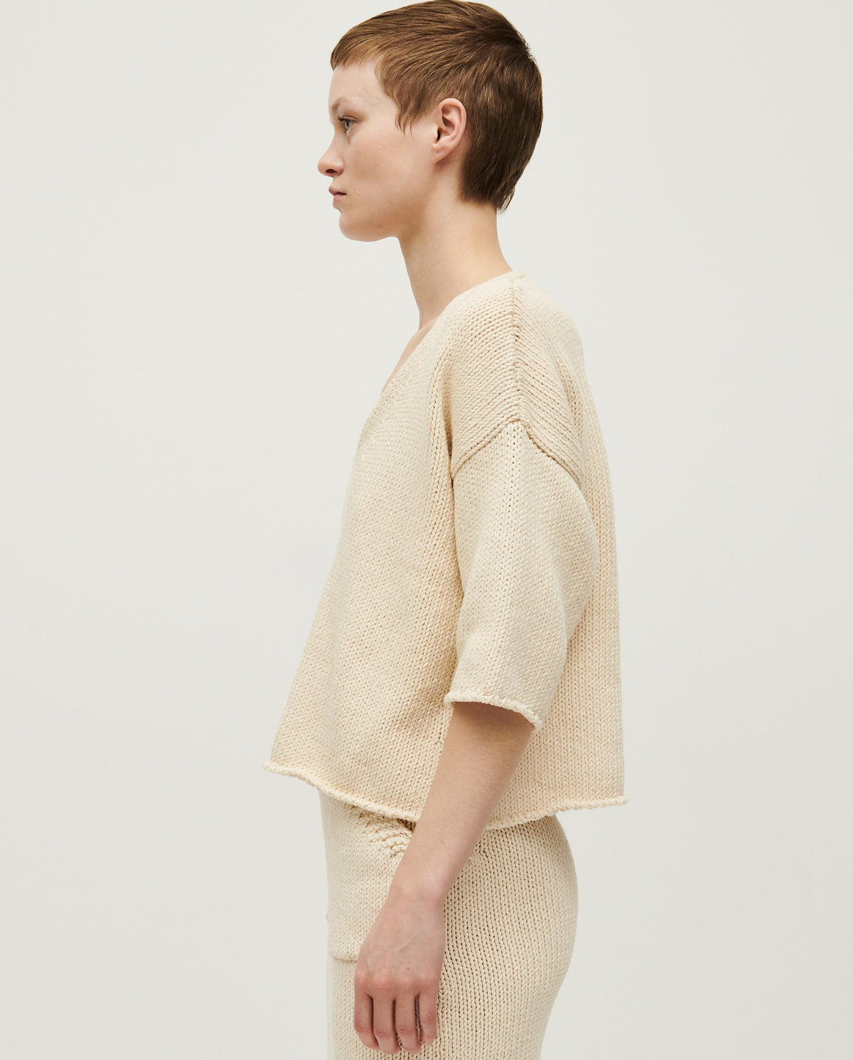 Woman wearing a Babaà No9 Natural jumper, showcasing its cozy, neutral-colored knit fabric and relaxed fit style.