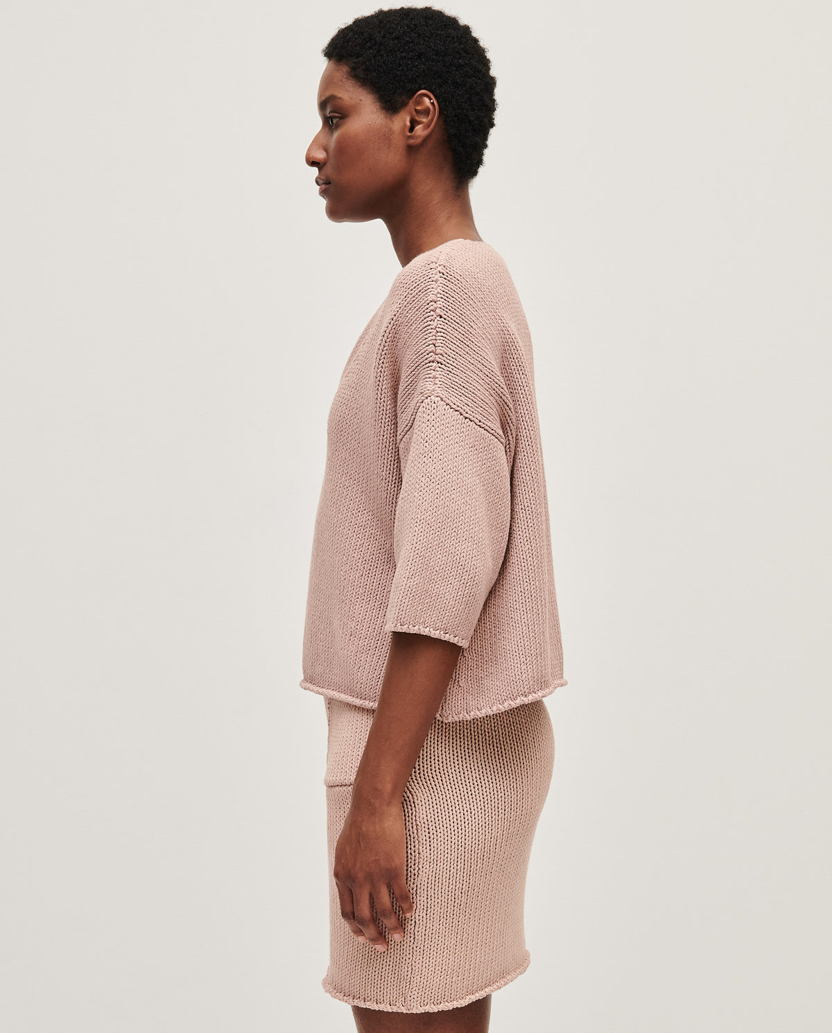 Babaà No9 plum blossom jumper worn by a woman, featuring a cozy knit design with a vibrant plum blossom pattern.