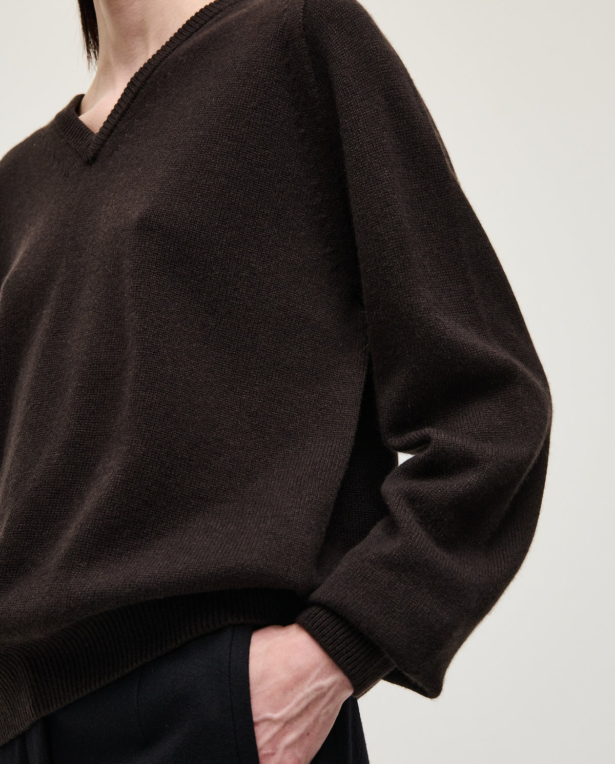 Black Babaà No91 Blackwood jumper worn by a woman, showcasing the cozy knit design and black color.