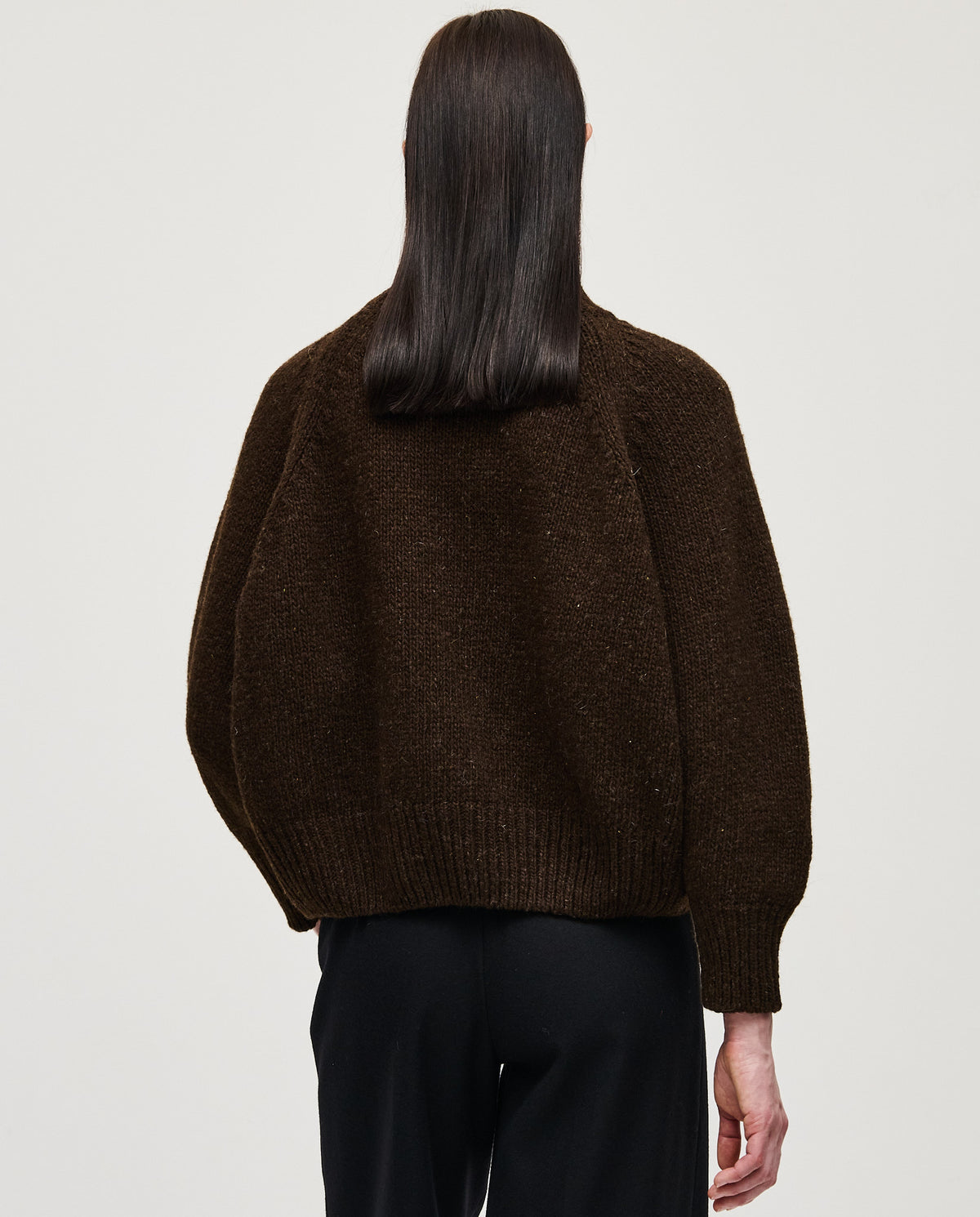 Babaà No95 Earth jumper worn by a woman, featuring a cozy, earthy-toned knit sweater with a relaxed fit.