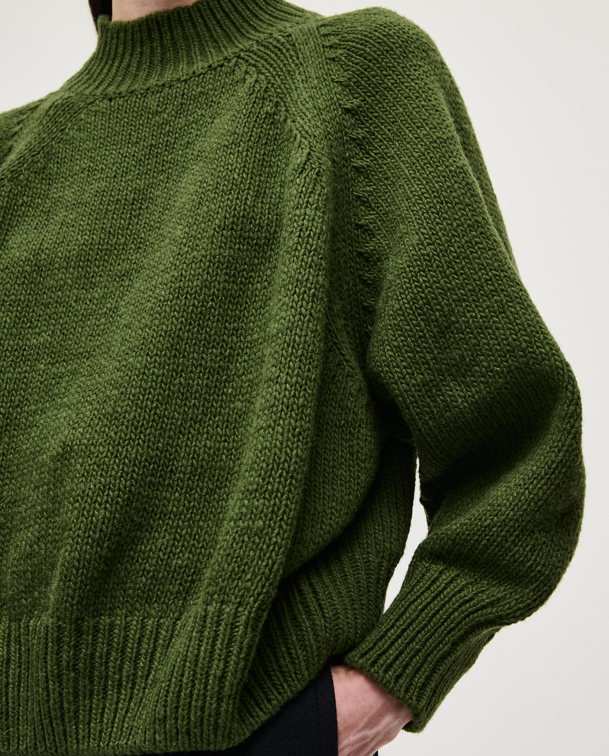 Babaà No95 Forest jumper worn by woman, featuring cozy knit fabric in forest green, casual style, and comfortable fit.