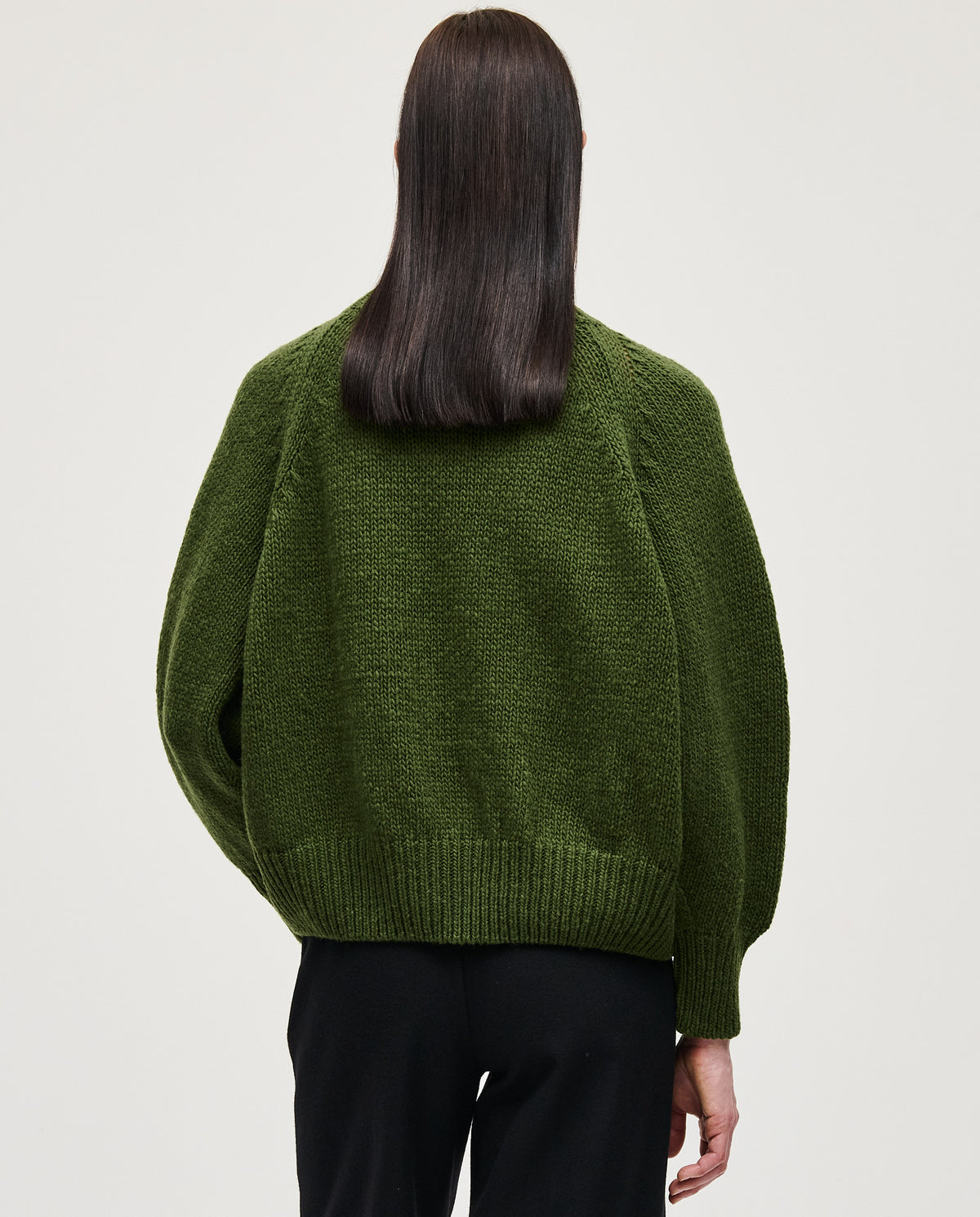 Babaà No95 Forest women's jumper featuring a cozy knit design in forest green, worn by a woman outdoors.